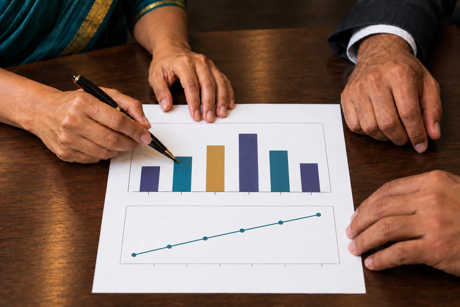 Two hands over a printed report, one annotating with a pen, the other pointing at a line