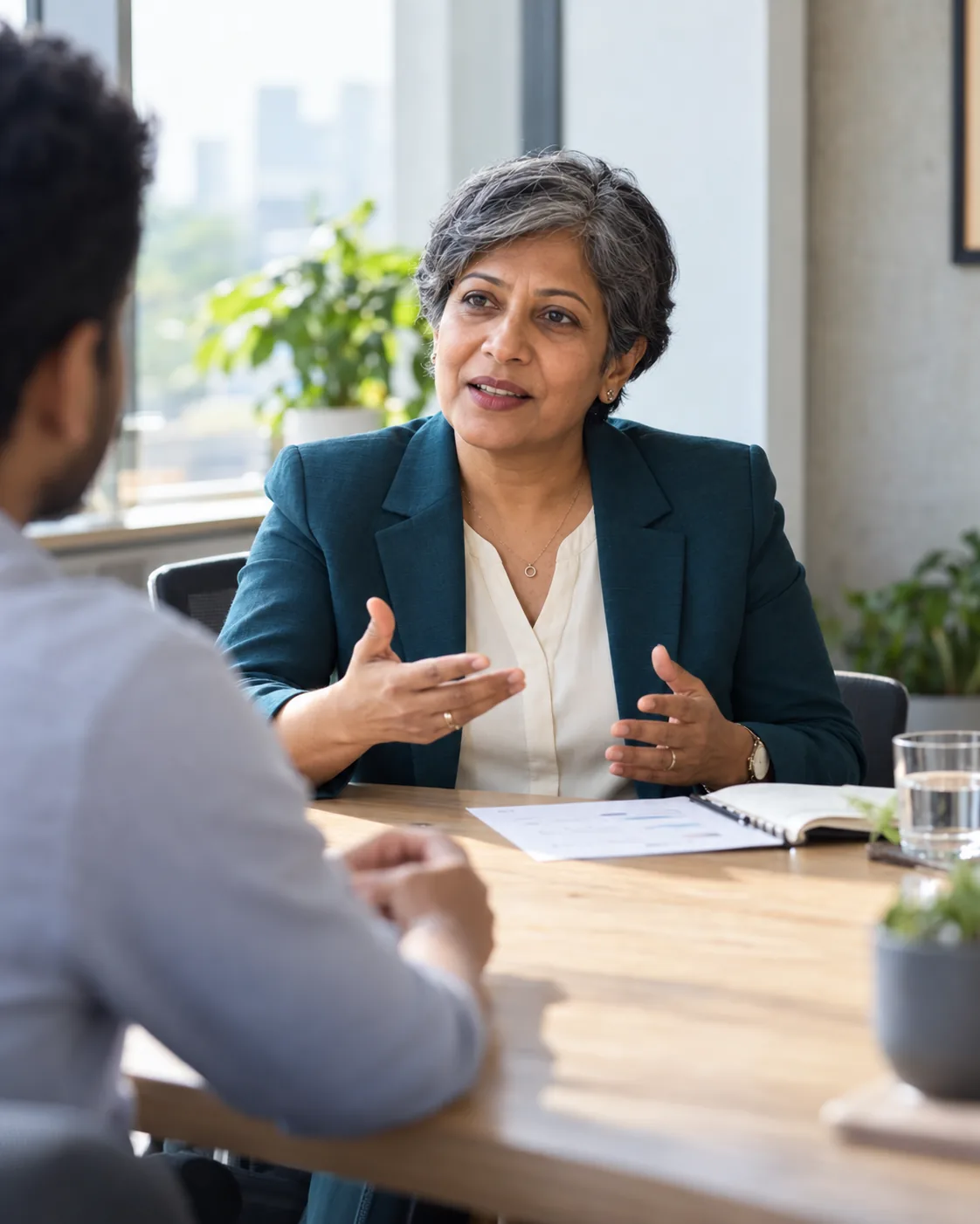 A senior Eshcol consultant explaining a point to a client across a meeting table