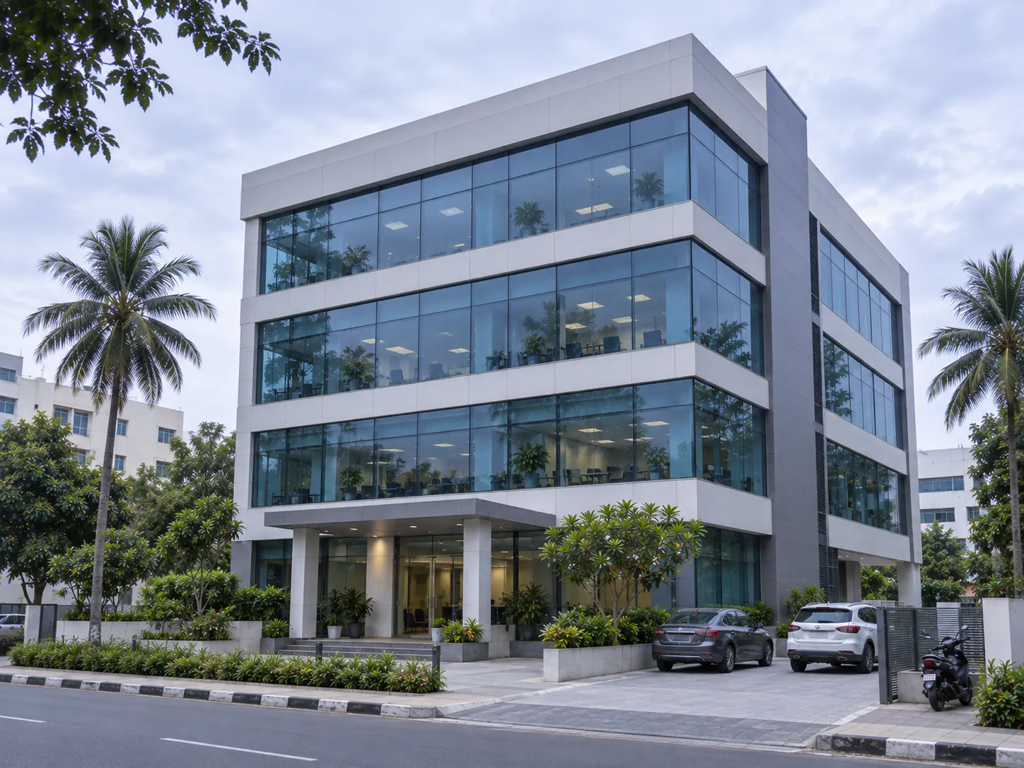 A modern commercial building in Chennai with three floors of glass-fronted offices, of the kind Eshcol manages