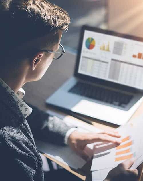 A man looking at the financial graphs